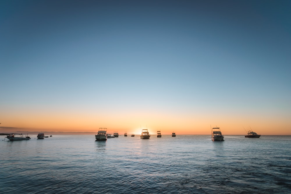 photo of boats under clear blue sky