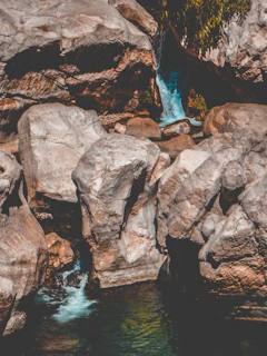 Close-up of the 7-meter waterfall cascading into the natural pool surrounded by rocks