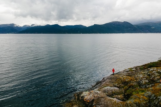 person standing near body of water in Ytre Oppedal Norway