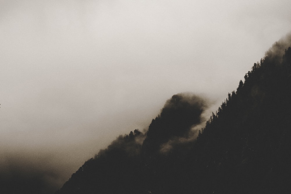 photo of mountain under white sky