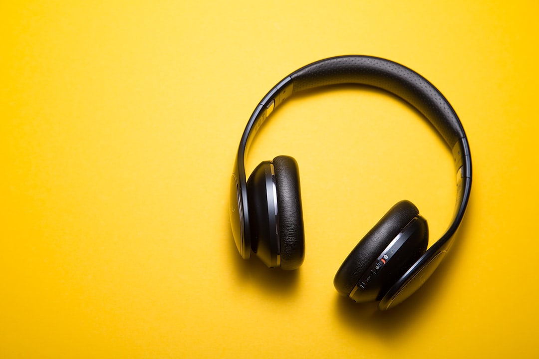 headphones laying on a yellow backdrop