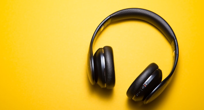 flatlay photography of wireless headphones