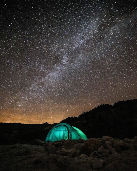 green tent under sky with stars in Aneto Spain