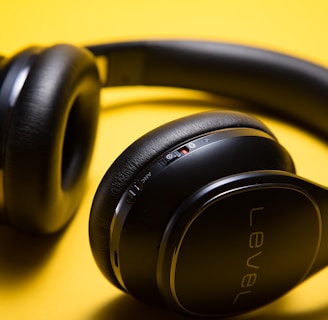black Level wireless headphones on yellow surface