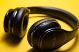 black Level wireless headphones on yellow surface