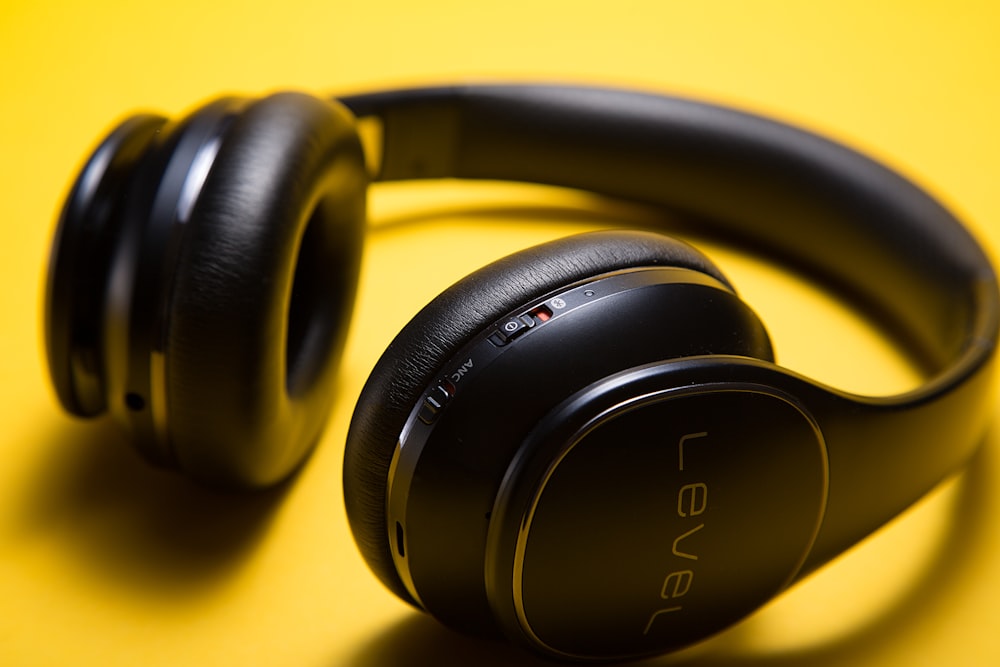 black Level wireless headphones on yellow surface