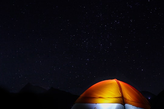 orange tent under the night sky in Pawna Lake India