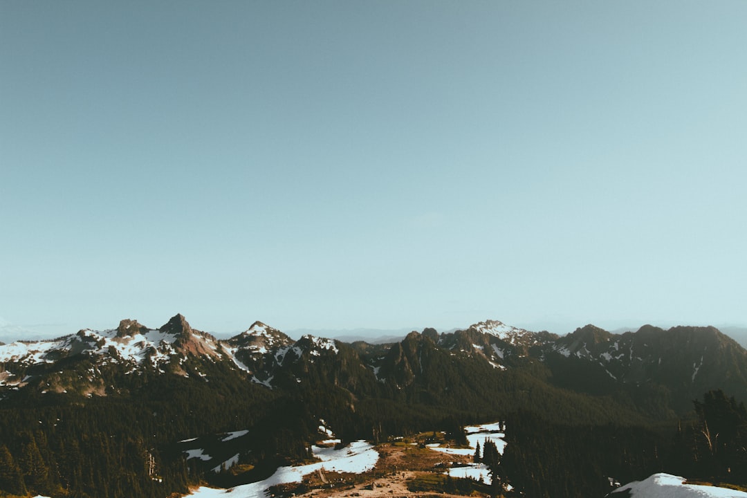 aerial photography of green mountain under clear blue sky