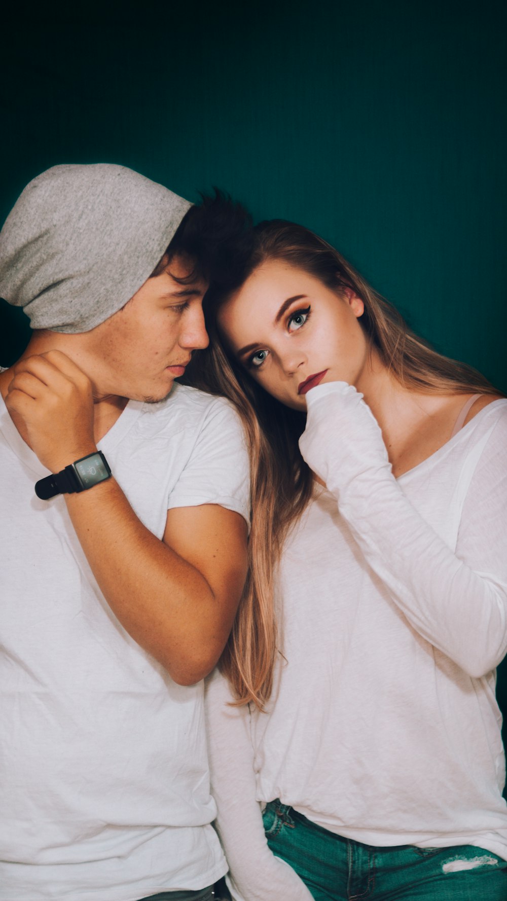 man standing beside woman while staring