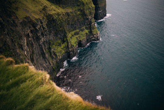body of water beside island in Cliffs of Moher Ireland