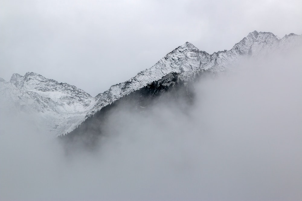 snow covered mountains near clouds