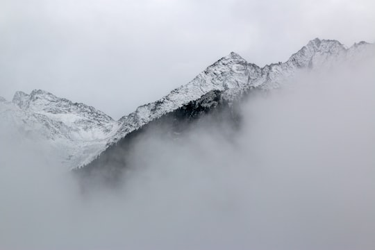 snow covered mountains near clouds in Rieserferner-Ahrn Nature Park Italy