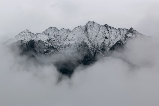 A mountain lake at dawn with mist rising off the still water
