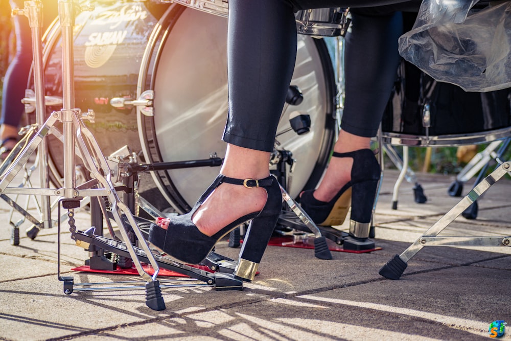 woman playing acoustic drum set