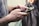 A close-up of hands holding a smartphone displaying a gaming app interface.