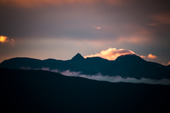 silhouette of mountain with clouds at golden hour in Hoonah United States