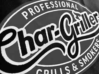 A close-up of a logo with the words 'Char-Griller' in bold, stylized font encircled by the phrases 'Professional Grills & Smokers'.
