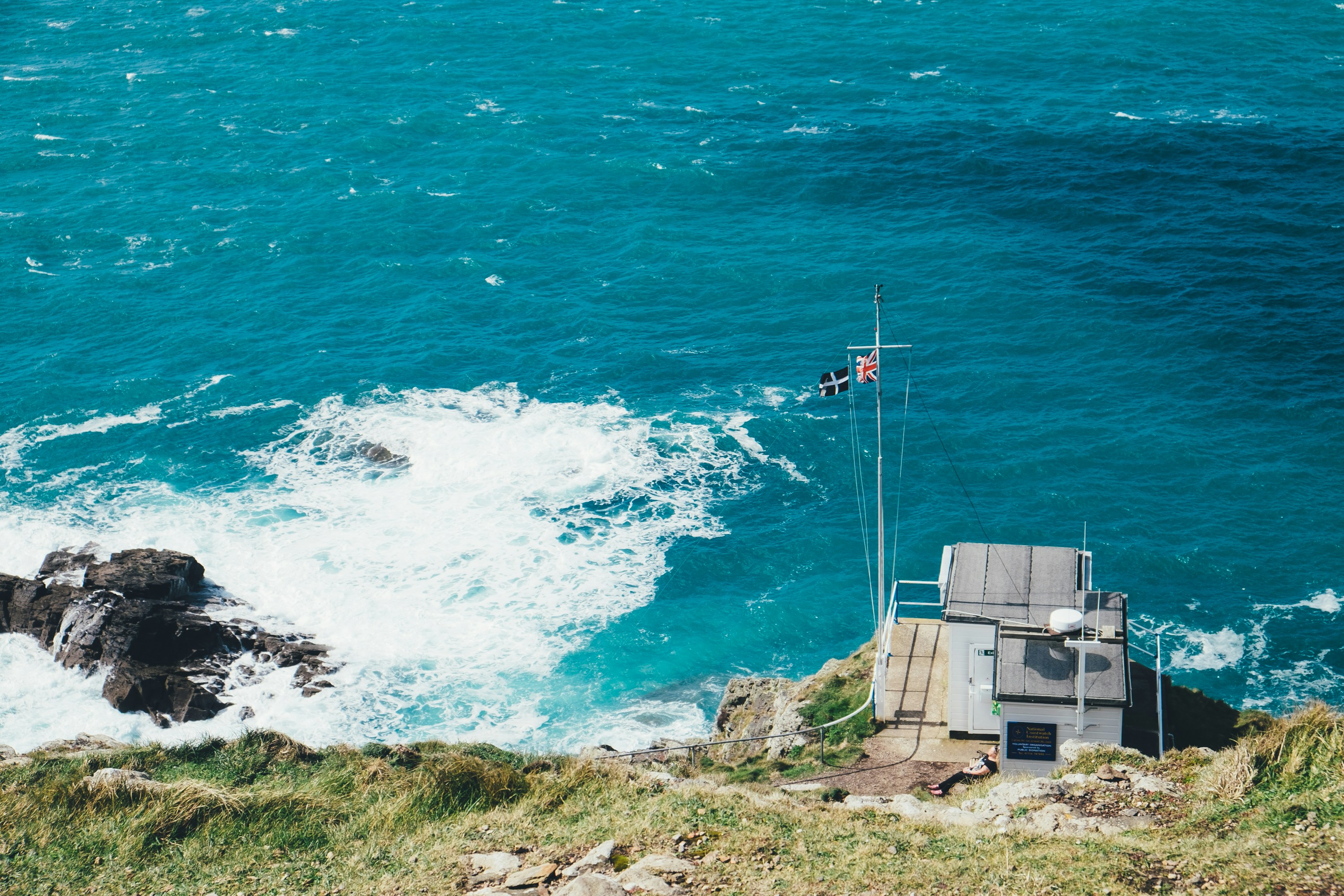 white shed station near sea