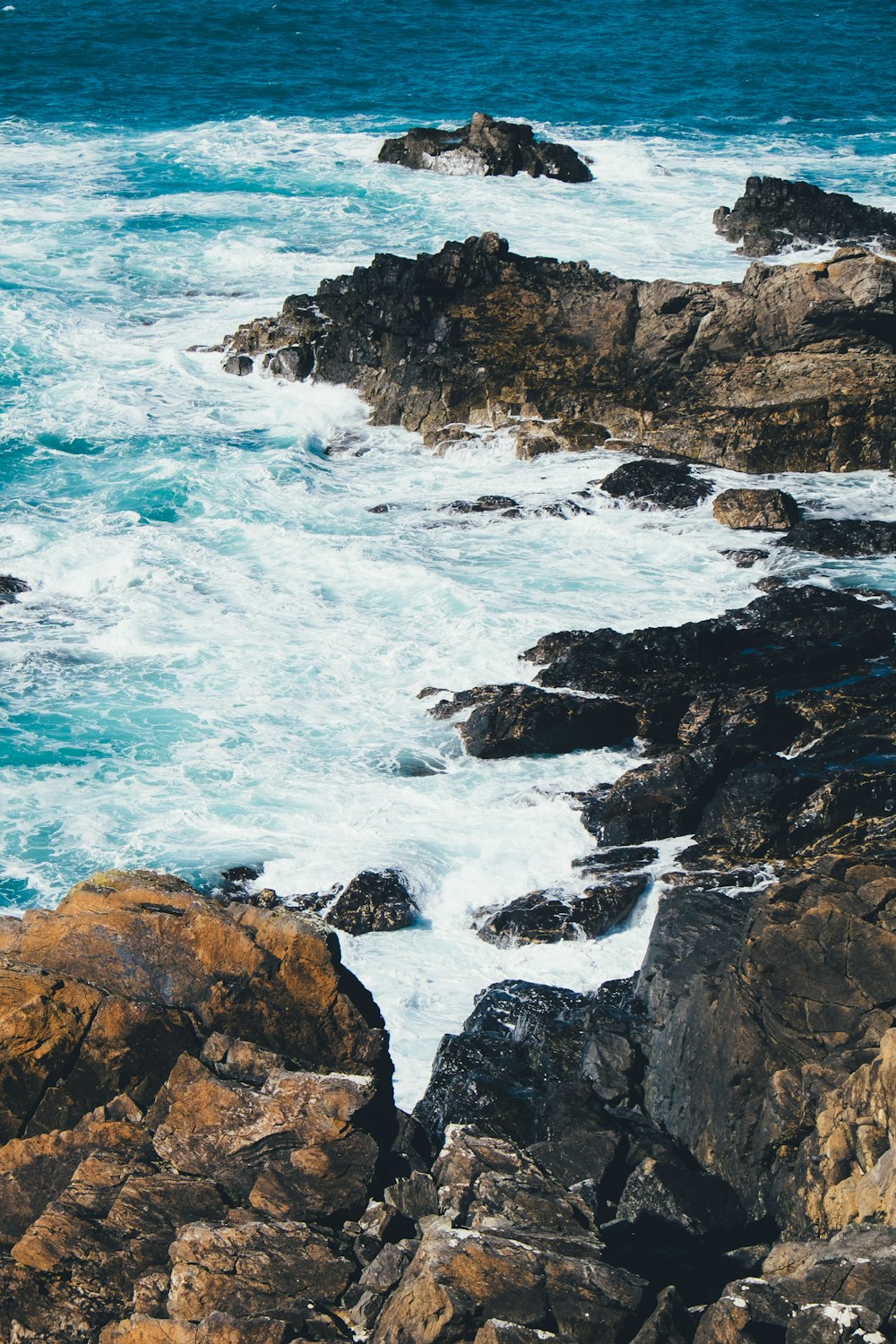 rock formation on sea with ocean waves