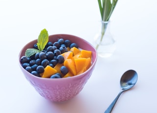 pink ceramic bowl besides spoon