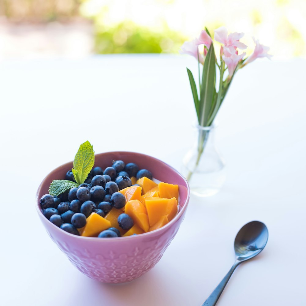 pink ceramic bowl besides spoon