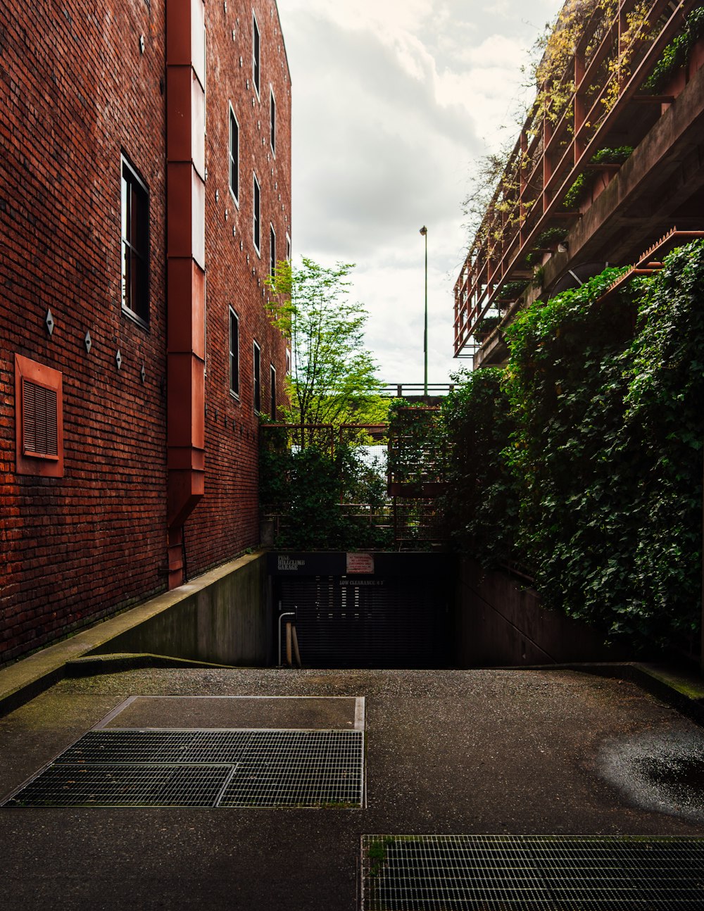 brown brick building near green plants during daytime