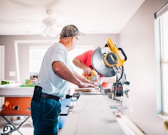 man standing infront of miter saw