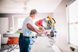 man standing infront of miter saw