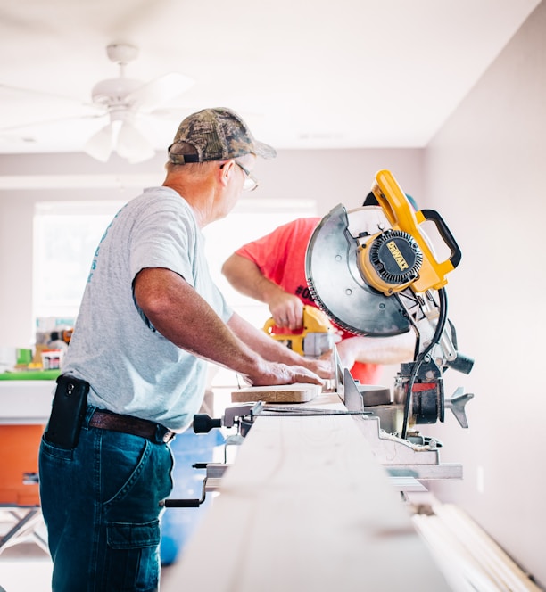 man standing infront of miter saw