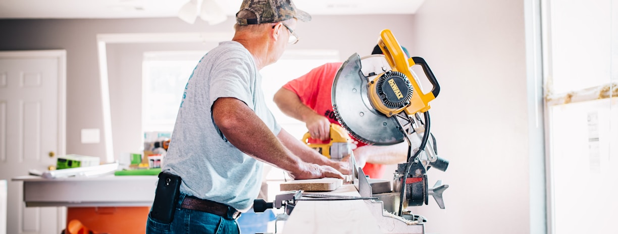 man standing infront of miter saw