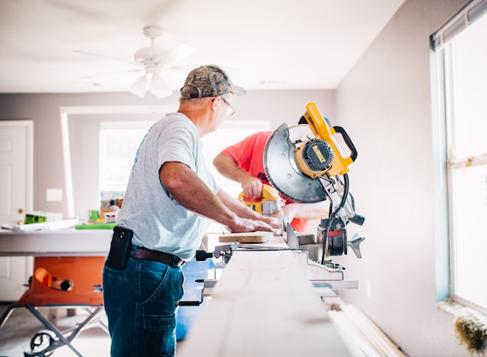 man standing infront of miter saw