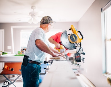 man standing infront of miter saw