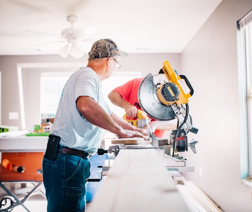 man standing infront of miter saw