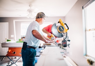 man standing infront of miter saw