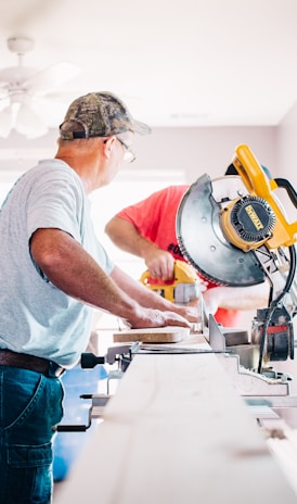 man standing infront of miter saw