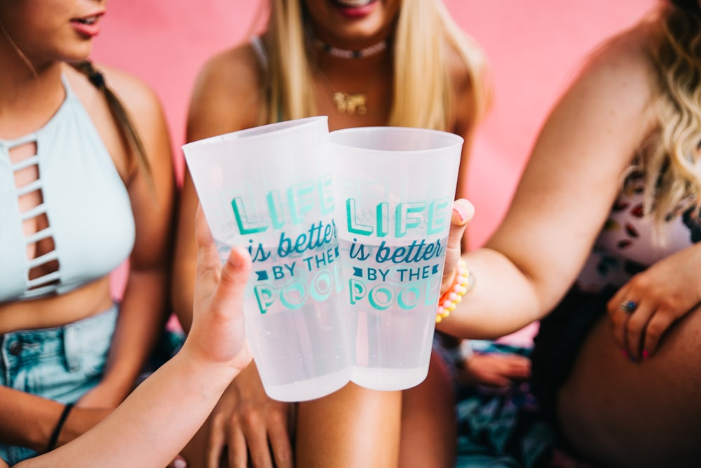 women holding two printed pint glasses