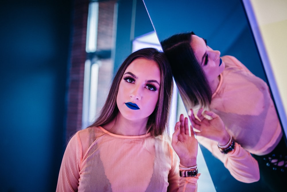 woman leaning on mirror