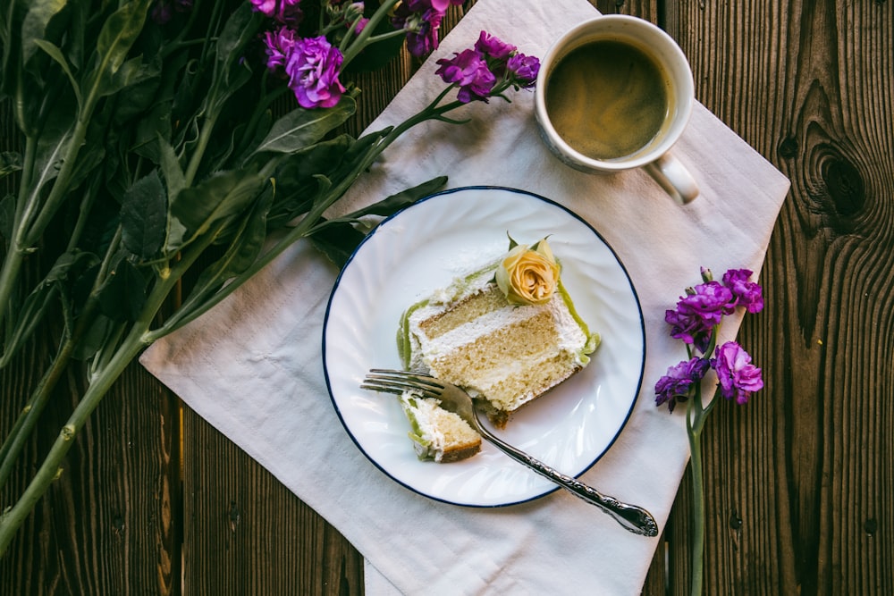 slice of cake on white ceramic plate with stainless steel fork