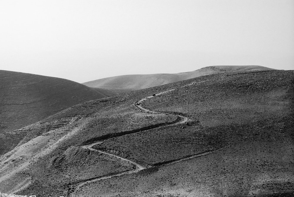 grayscale photo of zig-zag road