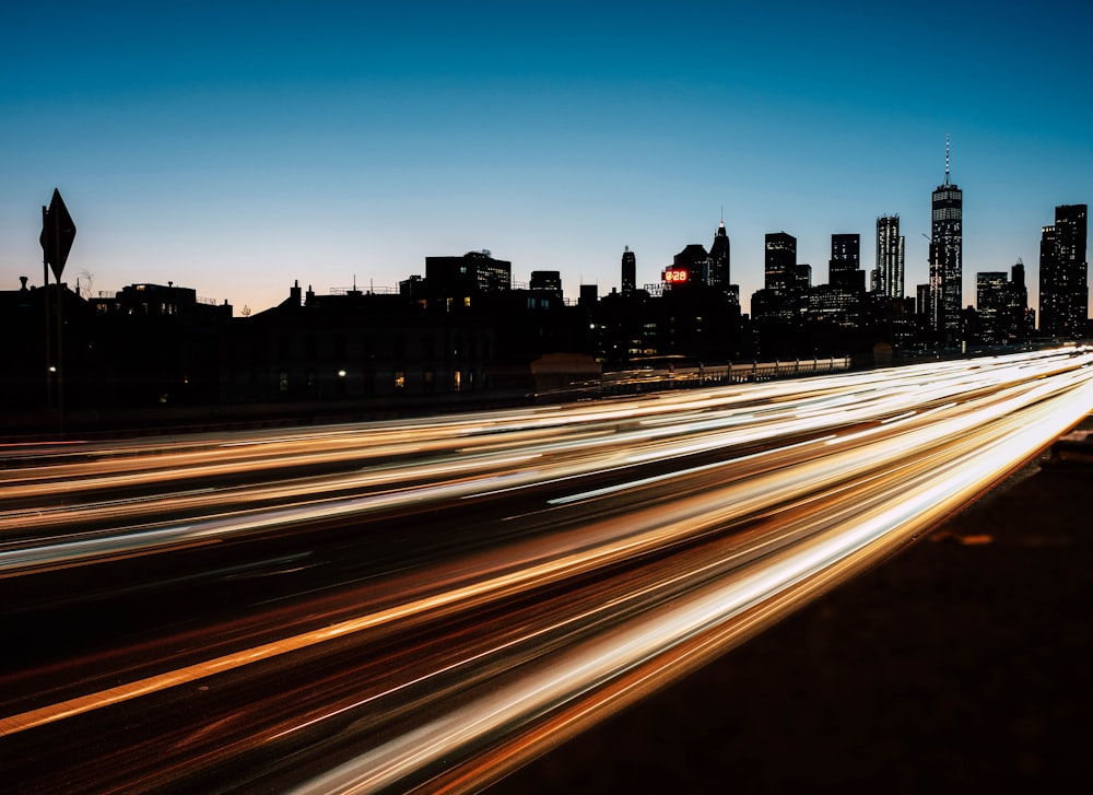 time lapse photography of passing vehicles on road