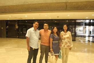 A warm and inviting photo of four health professionals smiling gently in a bright, calm wellness space.