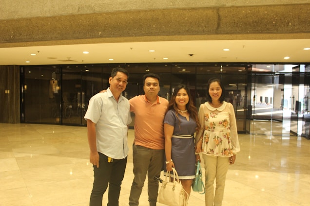 A warm and inviting photo of four health professionals smiling gently in a bright, calm wellness space.