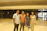 Smiling family standing proudly in their newly finished basement with bright lighting.