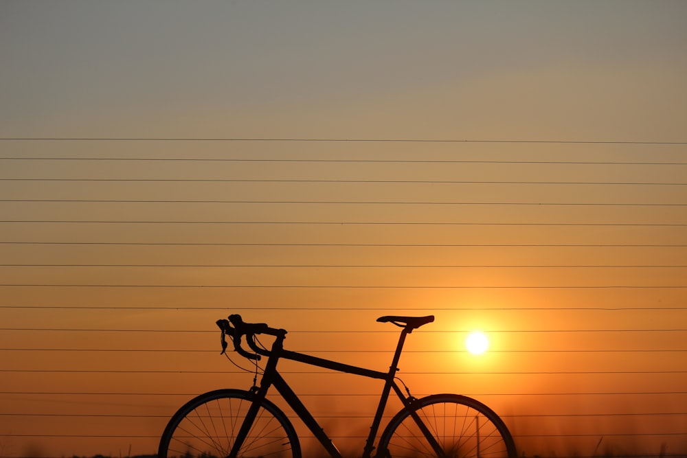 silhouette of road bicycle during sunset