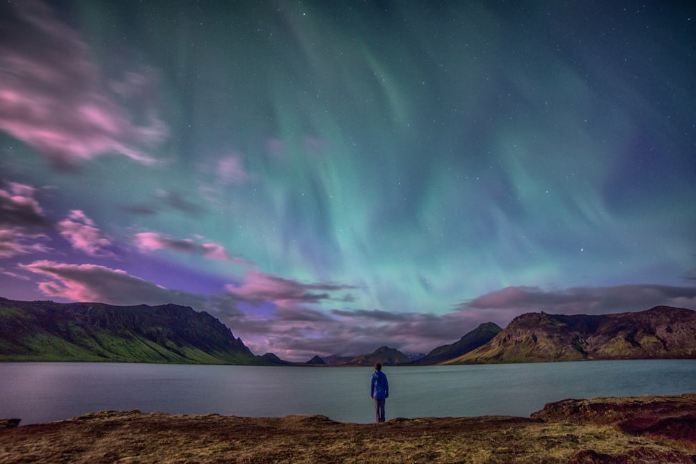 person standing front of body of water