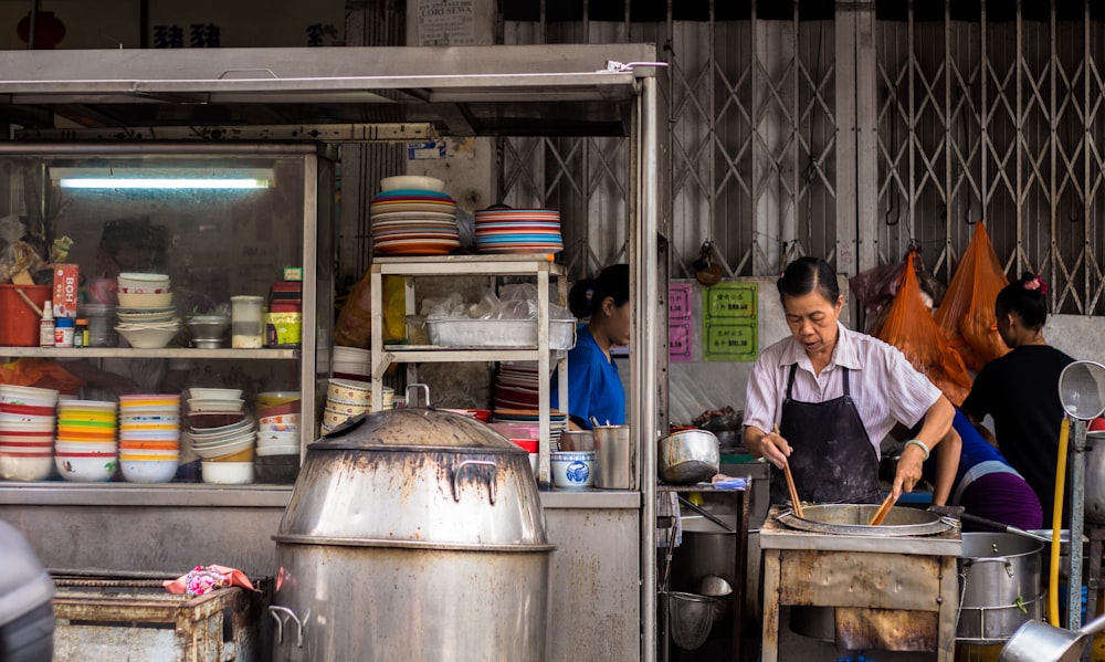 woman wearing black apron while cooking