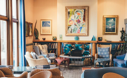 A warm, inviting living room in a residential care home with soft blue and purple accents.