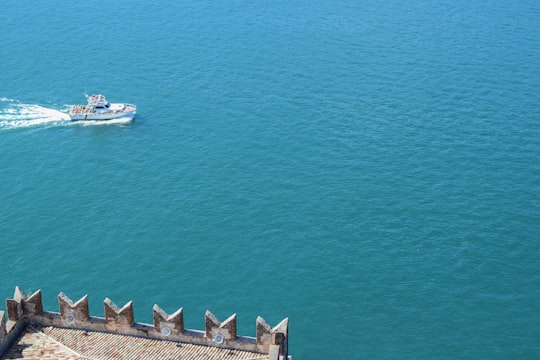 white motor boat sailing on ocean during daytime in Lake Garda Italy