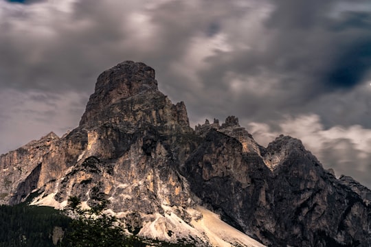 brown mountains covered by snow in Corvara Italy