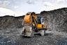 yellow and black excavator near hill